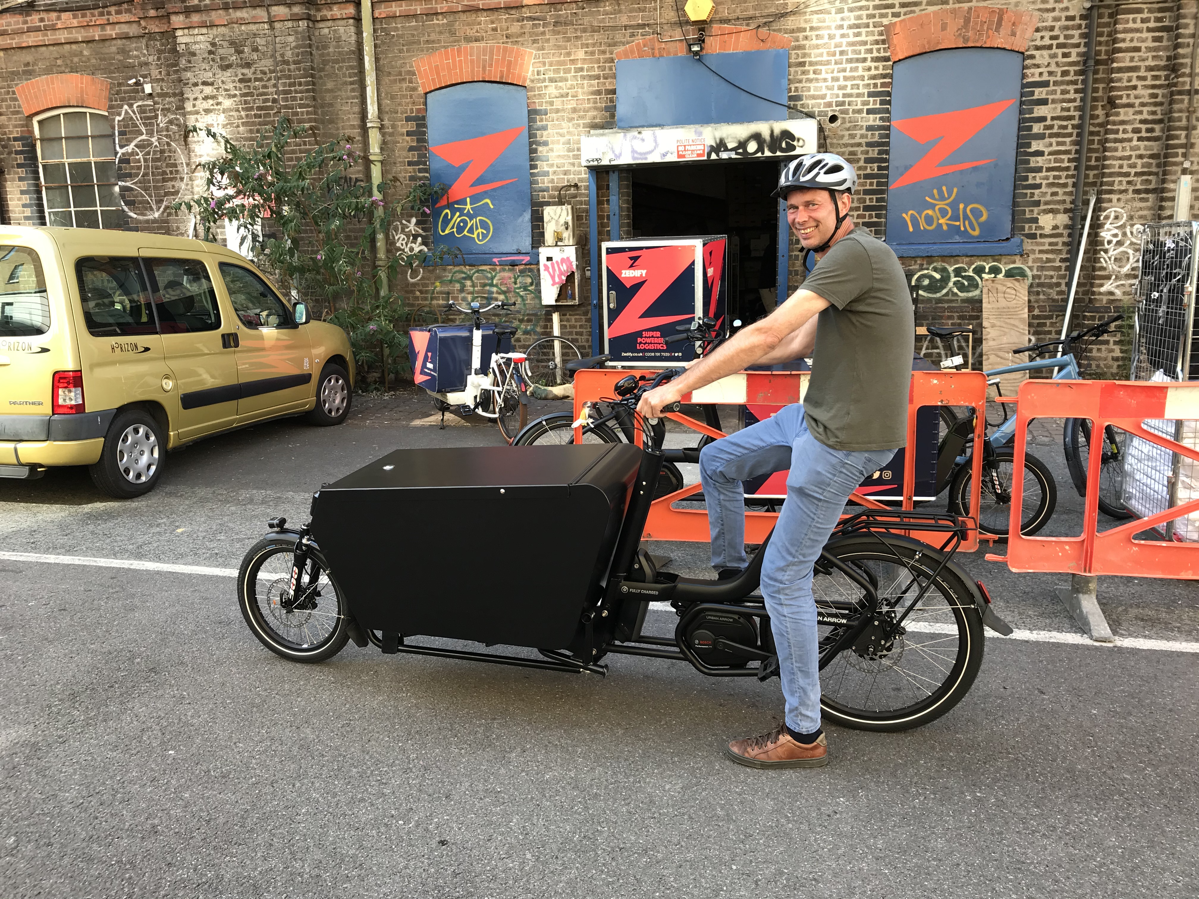 Man on an electric bike with a storage trunk attached to the front