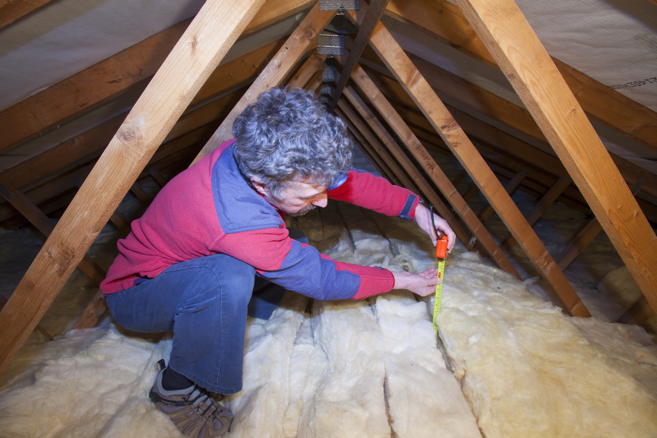 Person in a loft installing insulation