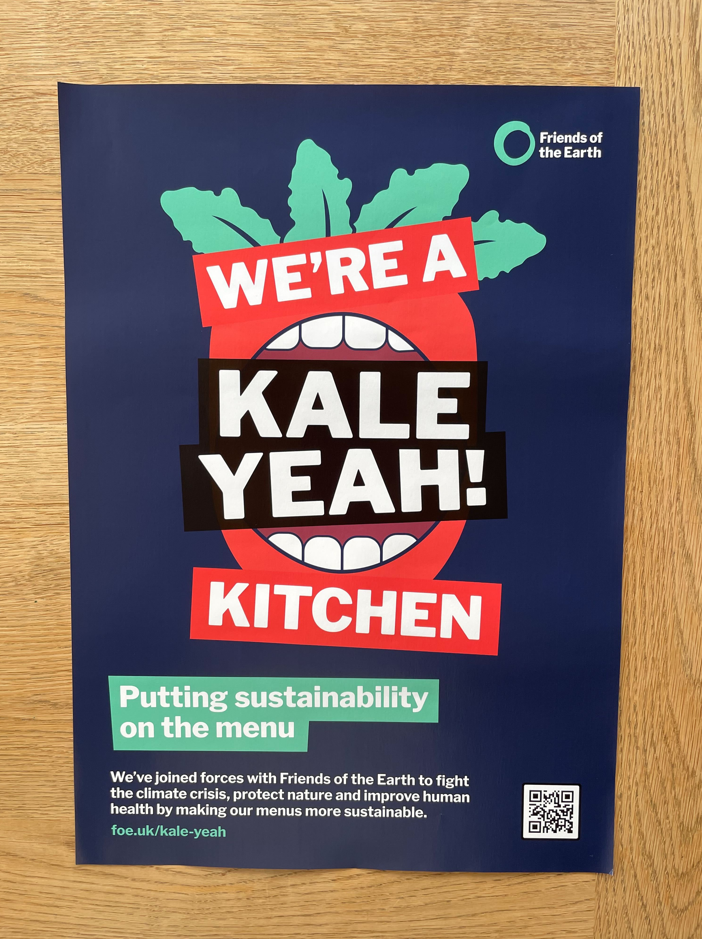 Poster that reads "We're a Kale Yeah! Kitchen" and includes info about the scheme