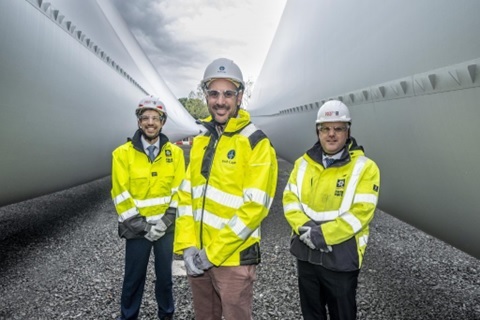 Three men in high vis jackets and hard hats posing for photo