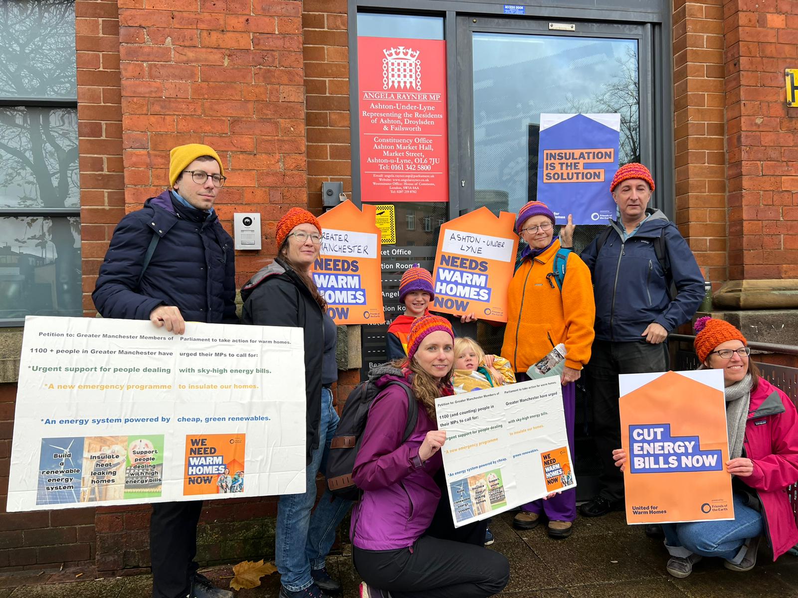 Manchester Friends of the Earth hand their petition into their MP's office on the Warm Homes Day of Action
