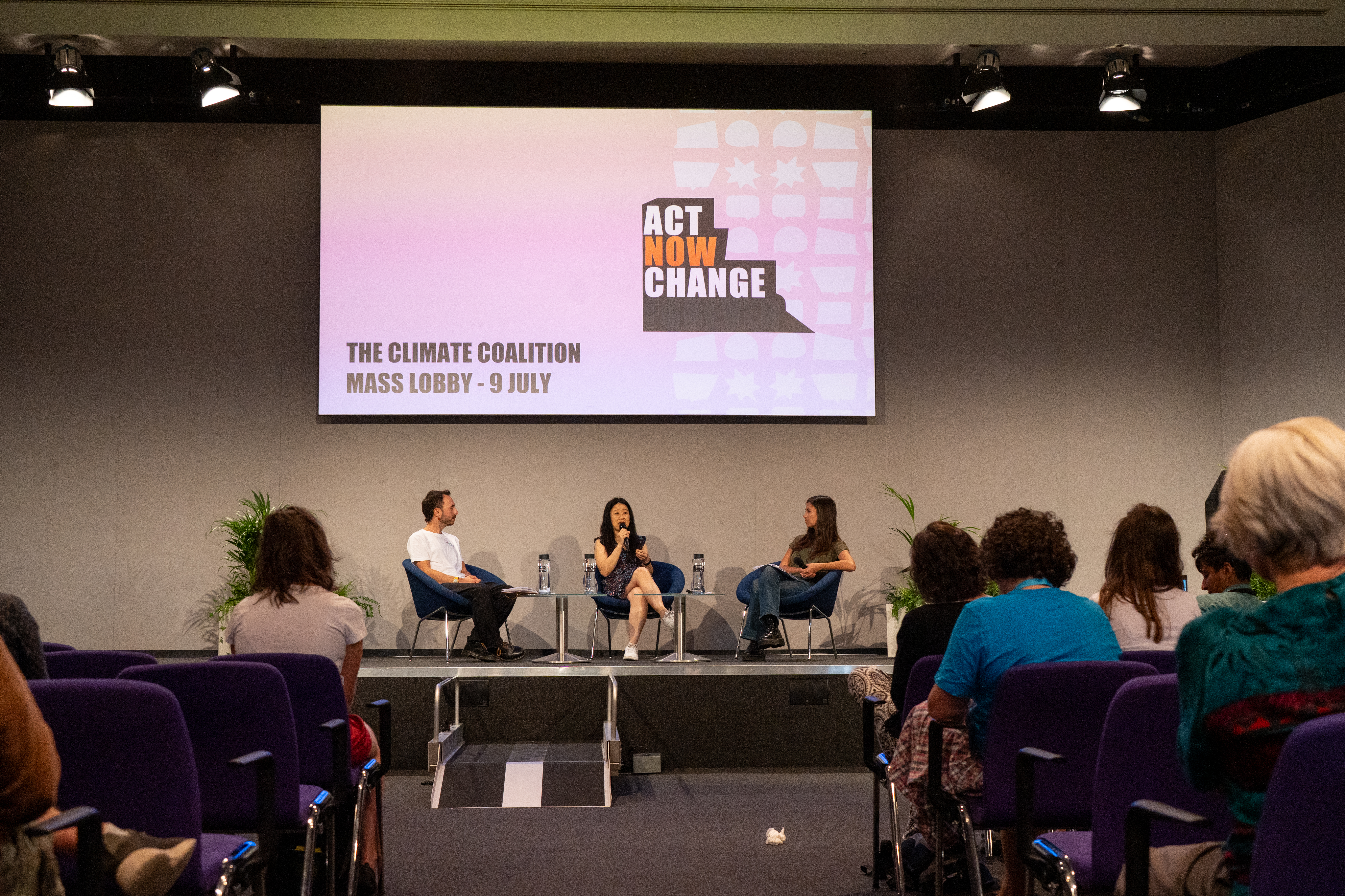 A panel of people chatting in a meeting space 