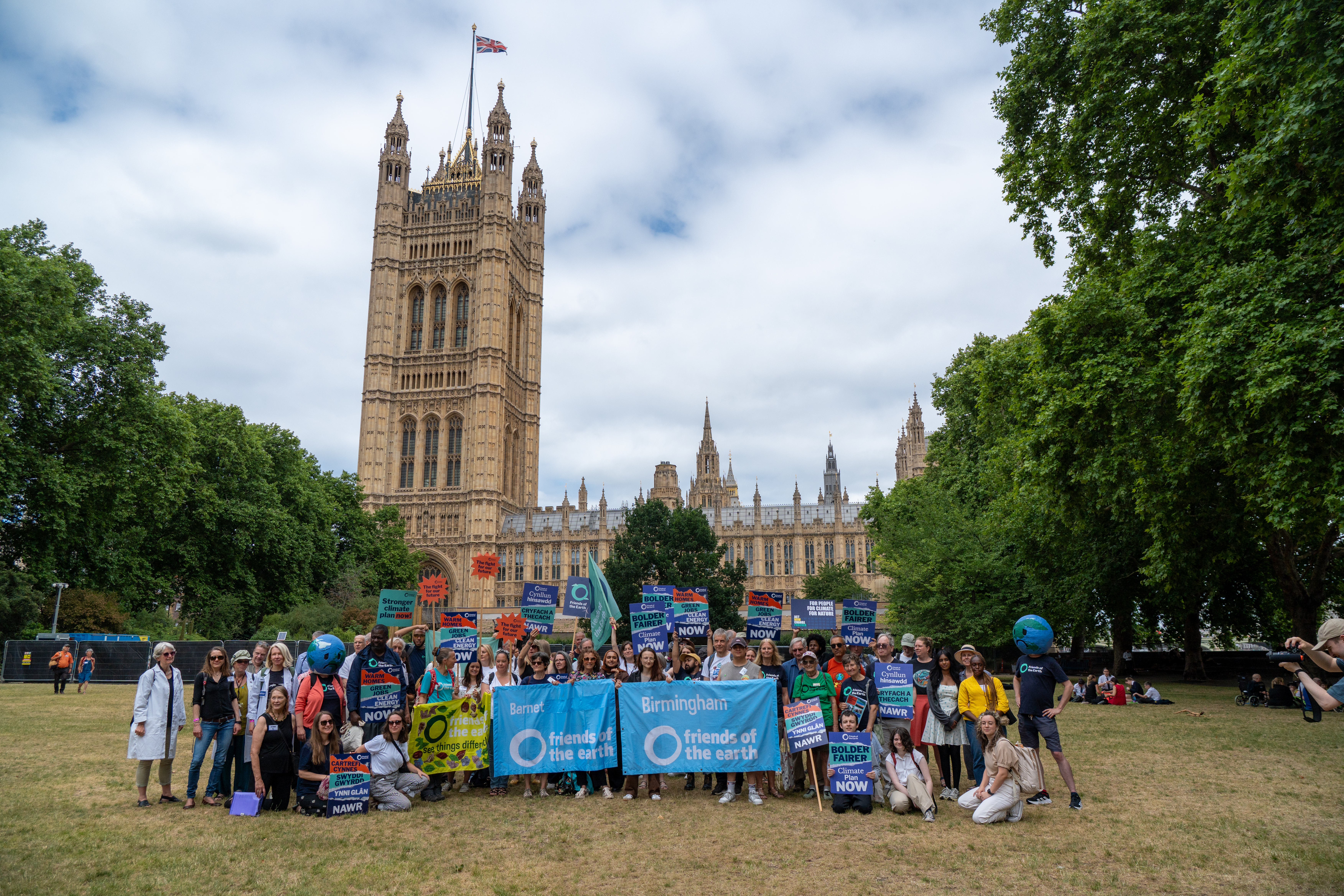 A large group of people outside of Westminster coming together for a photo to demand climate action