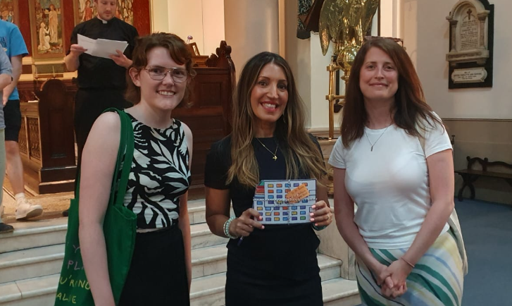 Balham Climate Action met their previous MP looking to be re-elected, Rosena Allin-Khan, at a hustings. They asked a question about warm homes and handed over postcards. Three people smiling for a photo