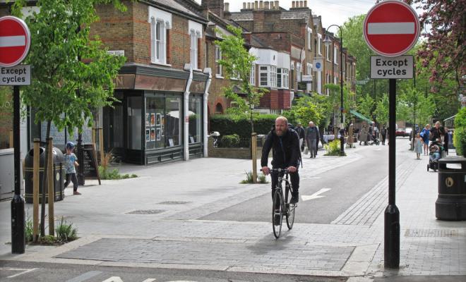 Man rides bike down cycle-only street