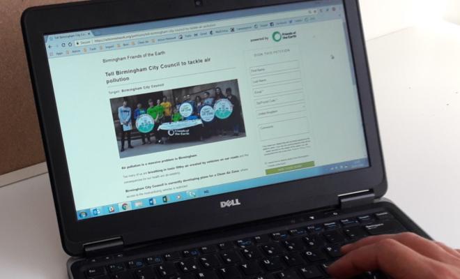 A laptop computer showing a digital petition